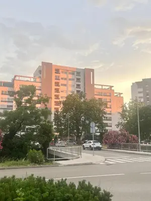 a car driving down a road in front of buildings at Apartment with Seaview Zetagradnja in Bar