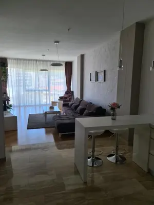 a living room with a couch and a table at TC BiG APARTMENTS in Budva