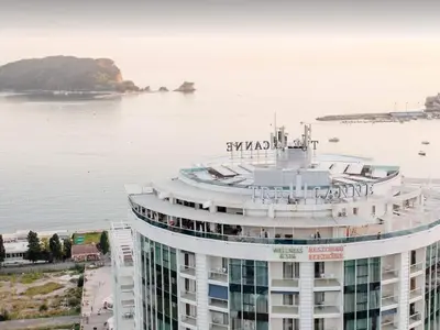 a large building next to a large body of water at TC BiG APARTMENTS in Budva