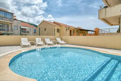 a large swimming pool with chairs at Blue Lagoon in Petrovac na Moru