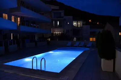 a swimming pool in the middle of a building at night at Blue Lagoon in Petrovac na Moru
