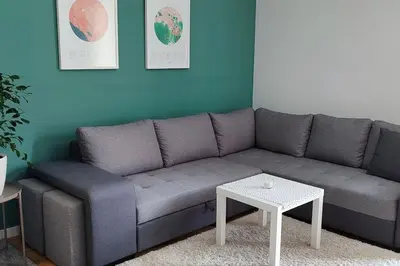 a living room with a gray couch and a table at Studio 357 Cetinje in Cetinje