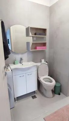 a bathroom with a toilet and a sink and a mirror at Studio 357 Cetinje in Cetinje