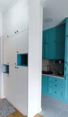 a blue and white kitchen with blue cabinets at Studio 357 Cetinje in Cetinje