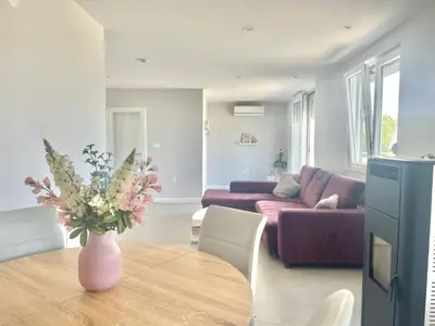a living room with a vase of flowers on a table at Family Apartments Stefan in Budva