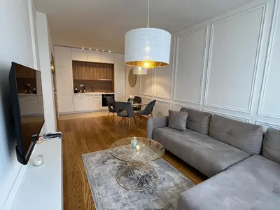 a living room with a couch and a table at Apartments Doclea in Podgorica