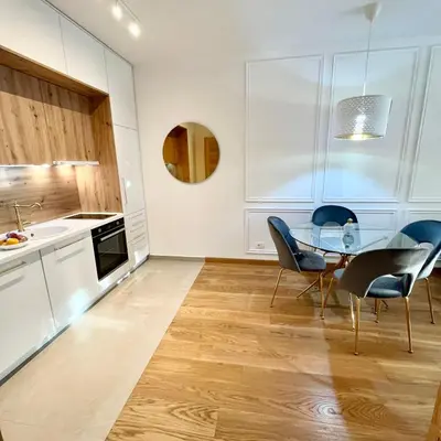 a kitchen and dining room with a glass table and chairs at Apartments Doclea in Podgorica