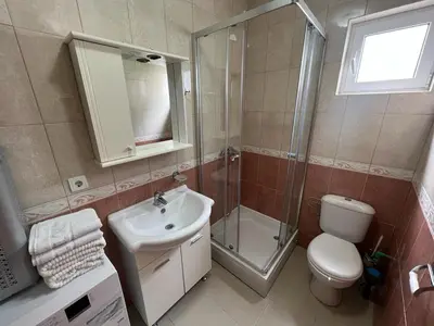 a bathroom with a toilet sink and a shower at Budva Apartments in Budva
