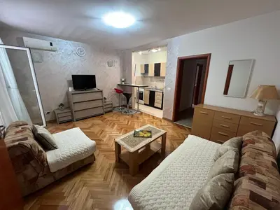 a living room with a couch and a table at Budva Apartments in Budva