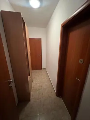 a hallway with an open door to a room with a hallway at Budva Apartments in Budva