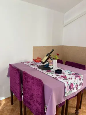 a purple table with purple chairs and a purple table cloth at Apartment Alex in Kotor