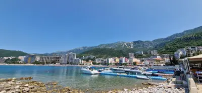 a group of boats are docked at a beach at APARTMANI NINI in Rafailovici