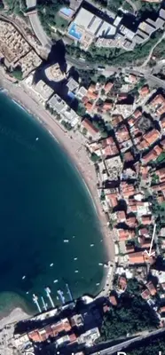 an aerial view of a village next to the water at APARTMANI NINI in Rafailovici