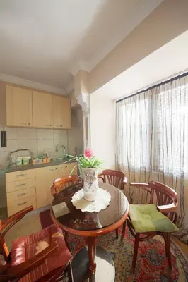 a kitchen and dining room with a table and chairs at Guest House Pansion 10 in Cetinje