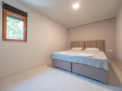 a bedroom with a bed and a window at Seaview Villa with pool-Vanja in Budva