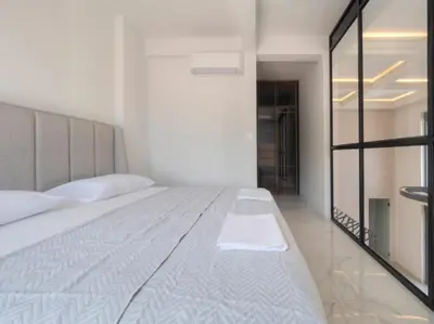 a bedroom with a large white bed and a mirror at Seaview Villa with pool-Vanja in Budva