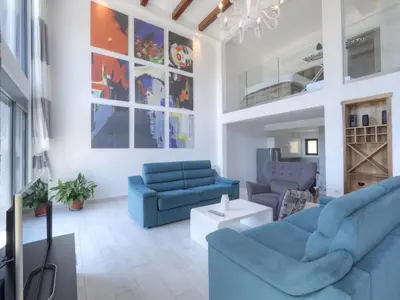 a living room with two blue couches and a table at Seaview Villa with pool-Vanja in Budva