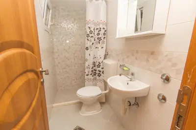 a small bathroom with a toilet and a sink at Apartments Petković in Petrovac na Moru