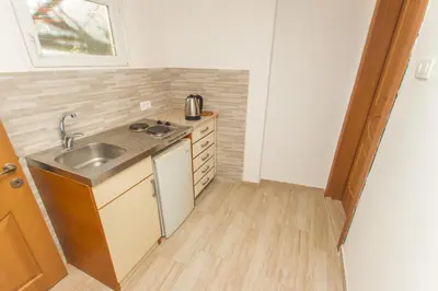 a small kitchen with a sink and a counter at Apartments Petković in Petrovac na Moru