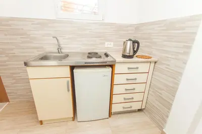 a kitchen with a sink and a counter top at Apartments Petković in Petrovac na Moru