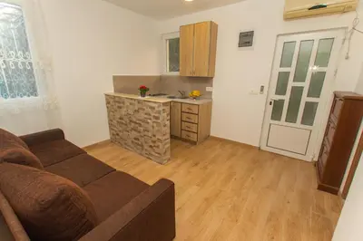 a living room with a couch and a kitchen at Apartments Petković in Petrovac na Moru