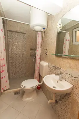 a bathroom with a toilet and a sink at Apartments Petković in Petrovac na Moru
