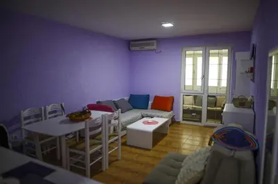 a living room with a couch and a table at Sutomore apartman in Sutomore