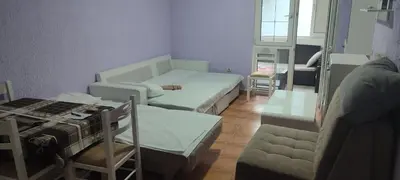 a small room with two beds and a table at Sutomore apartman in Sutomore