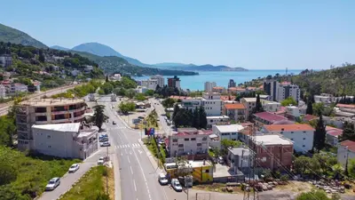 an aerial view of a city with the ocean in the background at Sutomore apartman in Sutomore
