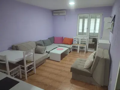 a living room with a couch and a table at Sutomore apartman in Sutomore