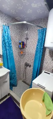a bathroom with a shower and a yellow sink at Sutomore apartman in Sutomore