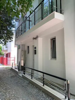 a white building with a balcony on top of it at LamijaApartmani 1 in Sutomore