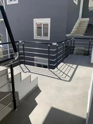 a stairway with a railing and stairs in a building at LamijaApartmani 1 in Sutomore