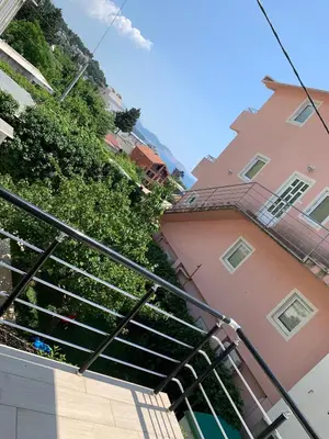 a building with a staircase in front of a building at LamijaApartmani 1 in Sutomore