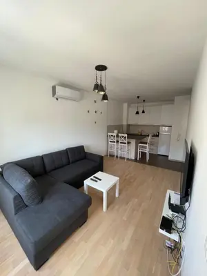 a living room with a couch and a table at Home Away Apartment in Podgorica