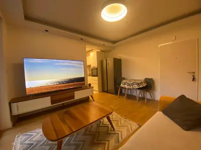 a living room with a large flat screen tv at Podgorica 23 in Podgorica