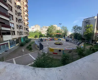 an empty parking lot with a playground in a city at Podgorica 23 in Podgorica