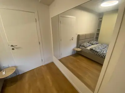 a small bedroom with a bed and a closet at Podgorica 23 in Podgorica