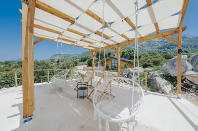 a view from the deck of a house with chairs at Olive Hills Holiday homes 1 & 2 in Bar