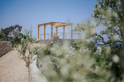 a structure on top of a hill with trees at Olive Hills Holiday homes 1 & 2 in Bar
