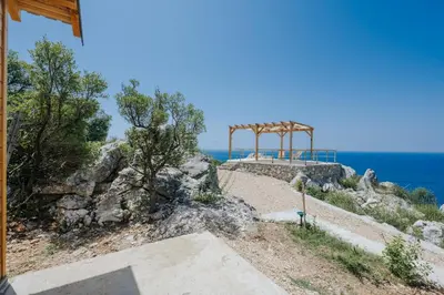 a wooden structure on top of a hill near the ocean at Olive Hills Holiday homes 1 & 2 in Bar
