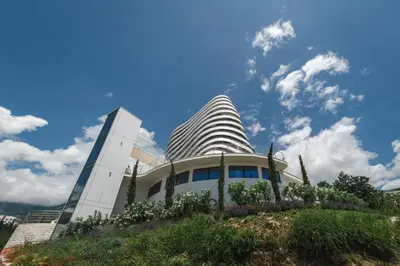 a building in front of a blue sky at La barca apartments in Becici
