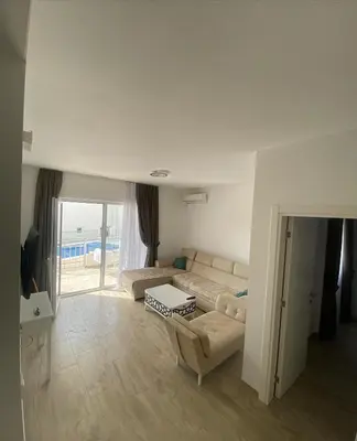 a living room with a couch and a table at Emma Lux Apartment in Dobra Voda