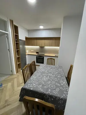 a kitchen with a table and chairs in a room at Pine forest apartment in Ulcinj