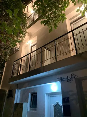 a building with a balcony on the side of it at LamijaApartmani in Sutomore