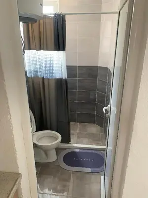 a small bathroom with a toilet and a shower at LamijaApartmani in Sutomore