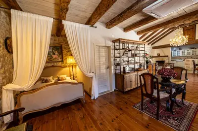 a bedroom with a bed and a table in a room at Stone Villa Oblun in Briđe