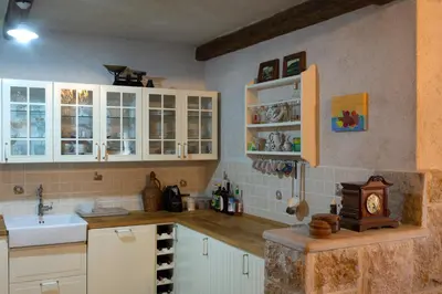 a kitchen with white cabinets and a sink at Stone Villa Oblun in Briđe