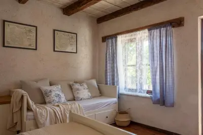a living room with a couch and a window at Stone Villa Oblun in Briđe