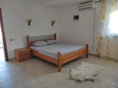 a bedroom with a bed and a rug at Vila Šeki in Bar
